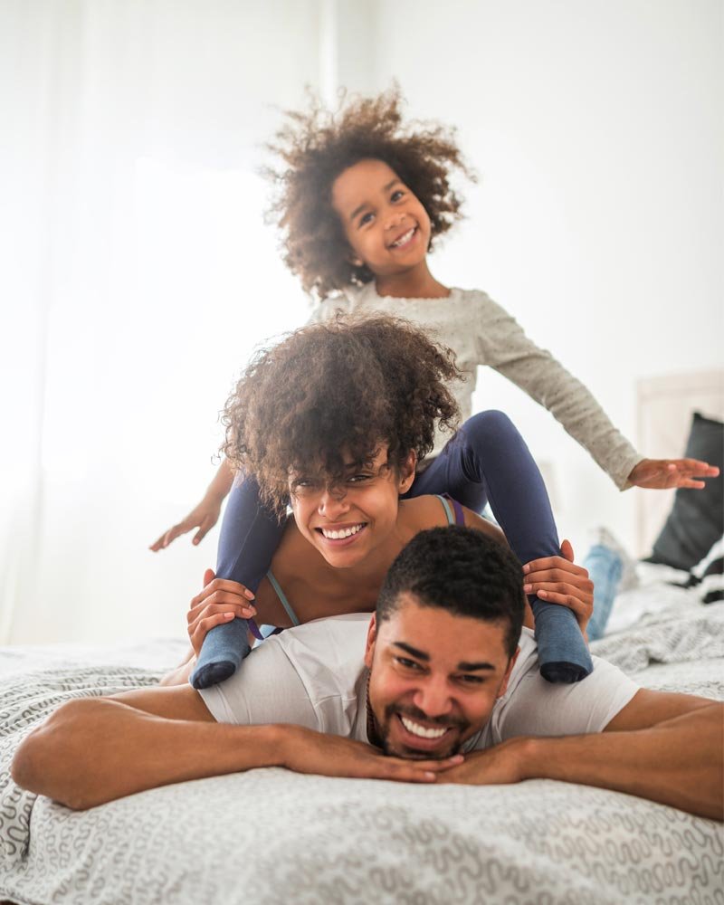 happy family on bed